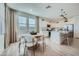 Bright kitchen with white cabinets, island seating, and an adjacent dining area at 10149 E Ursula Ave, Mesa, AZ 85212