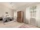 Bedroom with bright windows dressed with lace curtains and an armoire at 10287 E Verbena Ln, Scottsdale, AZ 85255