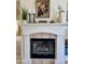 Elegant fireplace featuring decorative mantle with plants, candles, and artwork, adding charm to the living space at 10287 E Verbena Ln, Scottsdale, AZ 85255