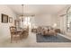 Open-concept living and dining area with neutral colors, large windows, and comfortable seating at 10287 E Verbena Ln, Scottsdale, AZ 85255