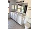 Bright bathroom featuring a dual sink vanity with white cabinets and a neutral countertop at 10528 W Jessie Ln, Peoria, AZ 85383