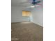 A bright bedroom featuring neutral carpeting and a window with modern privacy blinds at 10528 W Jessie Ln, Peoria, AZ 85383