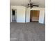 Carpeted bedroom with ceiling fan leading to the bathroom, and view of the hallway at 10528 W Jessie Ln, Peoria, AZ 85383