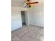 Bedroom with carpet and ceiling fan, showing a partially opened closet at 10528 W Jessie Ln, Peoria, AZ 85383