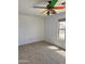 A carpeted bedroom featuring a brightly colored ceiling fan and natural lighting at 10528 W Jessie Ln, Peoria, AZ 85383