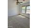 Bedroom with carpeted floors, two windows, and a multicolored ceiling fan at 10528 W Jessie Ln, Peoria, AZ 85383