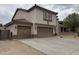 Tan two-story home featuring a tile roof and a three-car garage at 10528 W Jessie Ln, Peoria, AZ 85383