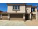 Two-story home featuring tan stucco, brown accents, and a spacious two-car garage at 10528 W Jessie Ln, Peoria, AZ 85383
