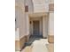 Covered entryway features a secure metal screen door and neutral color scheme at 10528 W Jessie Ln, Peoria, AZ 85383
