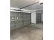 Spacious garage with concrete floors and gray doors provides ample parking and storage at 10528 W Jessie Ln, Peoria, AZ 85383