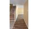 Hallway featuring a staircase, wood-look flooring, and a neutral color palette at 10528 W Jessie Ln, Peoria, AZ 85383