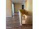 Upstairs hallway with wood floors featuring multiple doorways and stairs at 10528 W Jessie Ln, Peoria, AZ 85383