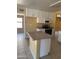 The open kitchen features white cabinets, an island, and appliances, creating a functional space at 10528 W Jessie Ln, Peoria, AZ 85383