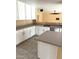 Bright kitchen featuring a gray countertop, white cabinets, and stainless steel dishwasher at 10528 W Jessie Ln, Peoria, AZ 85383