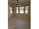 The living room is brightly lit with multiple windows and tile flooring at 10528 W Jessie Ln, Peoria, AZ 85383