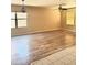 Inviting living room with wood-look flooring, modern lighting and large windows at 10528 W Jessie Ln, Peoria, AZ 85383