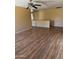 Large living room showcasing the wood flooring, ceiling fan, and neutral wall color at 10528 W Jessie Ln, Peoria, AZ 85383