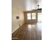 Well-lit living room with wood floors, large windows, and a fan at 10528 W Jessie Ln, Peoria, AZ 85383