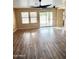 Sunlit living room featuring wood floors and a sliding glass door at 10528 W Jessie Ln, Peoria, AZ 85383