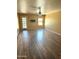 Spacious living room with wood-look flooring, fan, and a door to the outside at 10528 W Jessie Ln, Peoria, AZ 85383