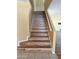 Staircase leading to the upper level, featuring wood-look flooring and white railings at 10528 W Jessie Ln, Peoria, AZ 85383