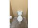 Picture of a standard white toilet in a simple tiled half-bathroom with neutral wall color at 10528 W Jessie Ln, Peoria, AZ 85383