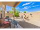 Inviting covered back patio with comfortable seating and a low-maintenance gravel yard at 10652 W Coronado Rd, Avondale, AZ 85392