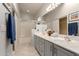 Bright bathroom featuring double sinks, a large mirror, and a shower-tub combination, perfect for a growing Gathering at 10652 W Coronado Rd, Avondale, AZ 85392