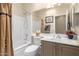 Bathroom featuring a shower and tub combination, vanity with countertop and framed mirror at 10652 W Coronado Rd, Avondale, AZ 85392