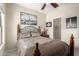 Bedroom featuring wrought iron bed frame, a nightstand with a lamp, and closet access at 10652 W Coronado Rd, Avondale, AZ 85392