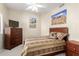 Cozy bedroom with wooden furniture, decorated with desert-themed artwork and neutral color palette at 10652 W Coronado Rd, Avondale, AZ 85392