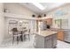 Spacious kitchen includes a stainless steel refrigerator, center island, and a separate dining area with bright windows at 10652 W Coronado Rd, Avondale, AZ 85392