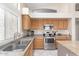 Bright kitchen featuring stainless steel appliances, neutral countertops, and light wood cabinets for a modern feel at 10652 W Coronado Rd, Avondale, AZ 85392