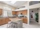 Well-lit kitchen with stainless steel appliances, center island, and ample wood cabinetry for storage and functionality at 10652 W Coronado Rd, Avondale, AZ 85392