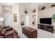 A spacious living room with high ceilings, comfortable leather sofas, and an open doorway to the Primary bedroom at 10652 W Coronado Rd, Avondale, AZ 85392