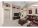 Spacious living room boasting high ceilings, neutral walls, a ceiling fan, and comfortable leather furniture at 10652 W Coronado Rd, Avondale, AZ 85392
