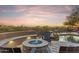 Stunning backyard featuring a fire pit, built-in seating, desert landscaping, and mountain views, perfect for outdoor living at 10811 E Acoma Dr, Scottsdale, AZ 85255