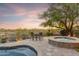Inviting backyard with a hot tub, mountain views, mature landscaping, and comfortable outdoor seating, ideal for relaxation at 10811 E Acoma Dr, Scottsdale, AZ 85255
