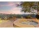 Inviting backyard with a hot tub, mountain views, mature landscaping, and comfortable outdoor seating, ideal for relaxation at 10811 E Acoma Dr, Scottsdale, AZ 85255