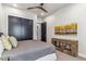 Stylish bedroom with dark closet doors, unique wood shelving, and neutral decor, creating a serene space at 10811 E Acoma Dr, Scottsdale, AZ 85255