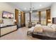Large bedroom with a ceiling fan, television, curtains, and covered windows at 10811 E Acoma Dr, Scottsdale, AZ 85255