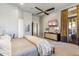 Comfortable bedroom featuring a ceiling fan, television, and covered windows at 10811 E Acoma Dr, Scottsdale, AZ 85255