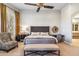 Bright bedroom with sitting area and a decorative mirror above a vanity at 10811 E Acoma Dr, Scottsdale, AZ 85255