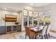 Bright dining room with backyard views and a stylish wine bar at 10811 E Acoma Dr, Scottsdale, AZ 85255