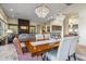 Elegant dining room with chandelier, opening to living room and kitchen at 10811 E Acoma Dr, Scottsdale, AZ 85255