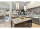 Gourmet kitchen with stainless appliances, island, and views at 10811 E Acoma Dr, Scottsdale, AZ 85255