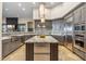 Modern kitchen with stainless steel appliances and breakfast bar at 10811 E Acoma Dr, Scottsdale, AZ 85255
