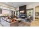 Spacious living room with sleek fireplace, display shelving, and luxurious furnishings at 10811 E Acoma Dr, Scottsdale, AZ 85255