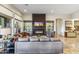 Contemporary living room with a sleek fireplace and neutral-toned furniture at 10811 E Acoma Dr, Scottsdale, AZ 85255