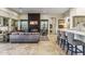 Living area with fireplace, bar access, and view of the dining area at 10811 E Acoma Dr, Scottsdale, AZ 85255